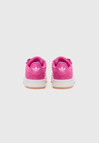 Pink sneakers with a suede upper, white rubber midsole, and gum outsole. Features a logo on the heel and round laces. Rear view.