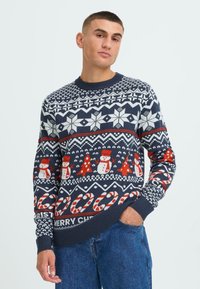 Navy blue Christmas sweater with white snowflakes, red snowmen, and candy cane patterns. Ribbed cuffs and hem. Text reads "Merry Christmas."