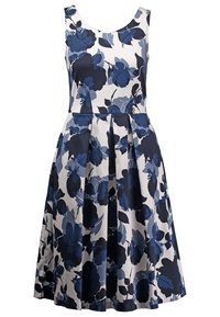 Vestido floral con flores en azul marino y azul sobre un fondo blanco. Diseño sin mangas, escote redondo y falda plisada. Material de algodón.