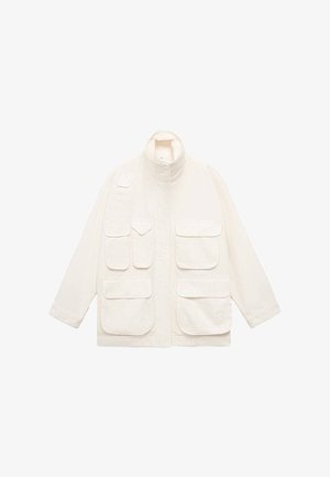 Light beige jacket made of cotton, featuring a high collar, multiple front pockets, and a relaxed fit with long sleeves.