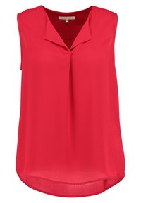 Punainen päällään ilman hihoja oleva pusero, joka on tehty sileästä kankaasta, ja siinä on v-aukko sekä kaareva helma, tarjoten rento istuvuus. Ei kuvioita tai koristeluja.