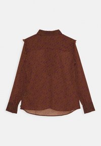 Blouse longue marron à manches longues avec un motif floral dans des tons de violet et d'orange, dotée d'un col et d'un ourlet arrondi.