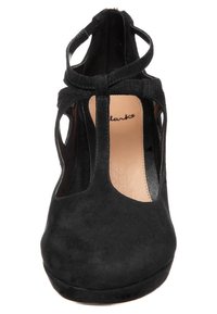 Černé semišové T-bar boty s výřezovými detaily a zaoblenou špičkou. Lehce polstrovaný interiér, obsahující značkovou stélku od Clarks.