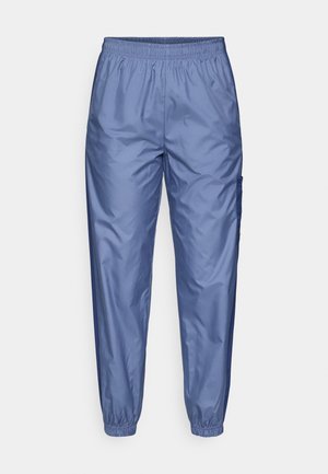 Heledad sinine, läikiv spordipüksid, millel on elastne vöökoht, kitsenevad säärted ja külgmine kaar. Valmistatud siledast, kergest kangast.