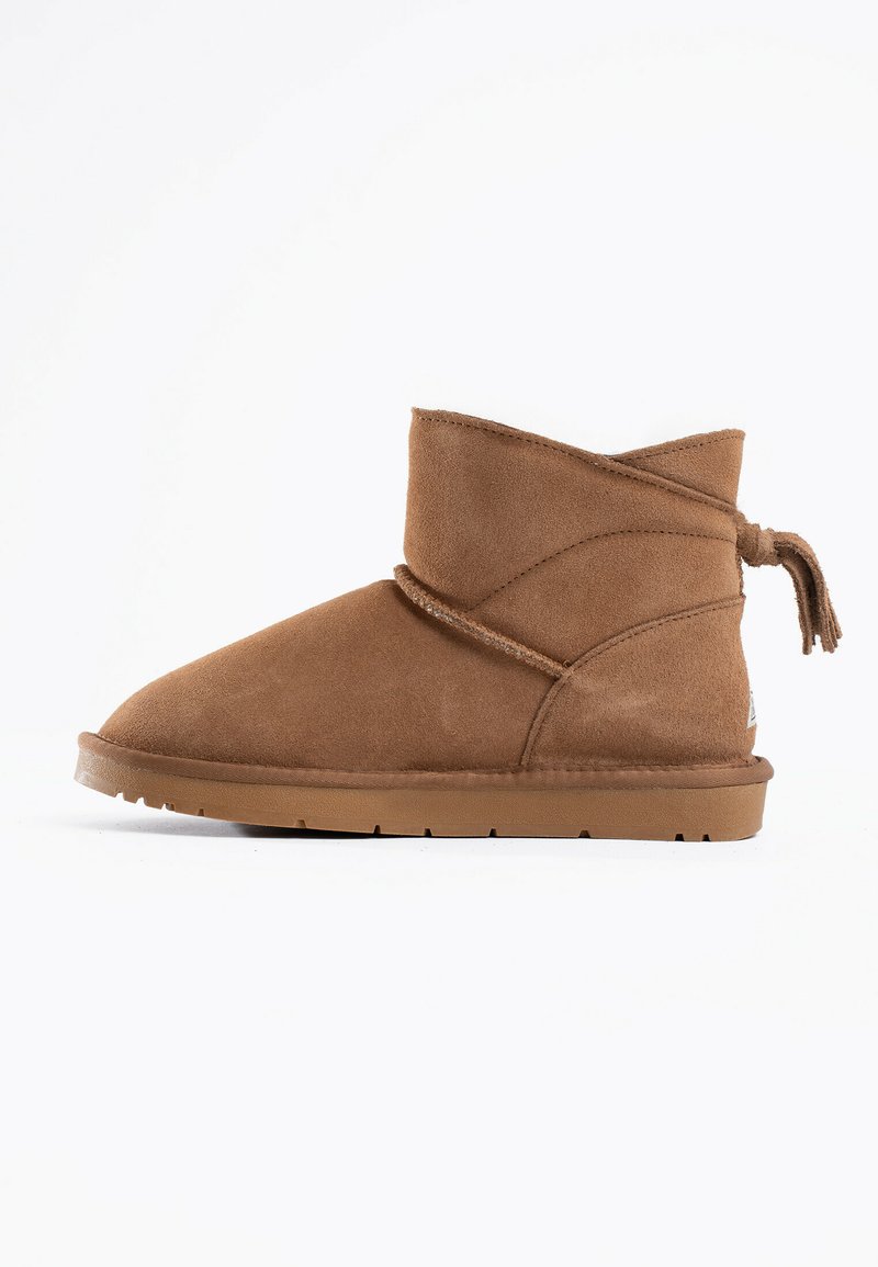 Stivale alla caviglia in suede marrone con tacco basso, design avvolto e un tassello decorativo sul retro. Presenta una suola in gomma per una maggiore durata.