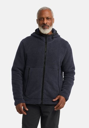 Veste en polaire bleu marine, dotée d'une fermeture éclair, d'une capuche et de deux poches avant. Texture douce avec un design à panneaux cousus.