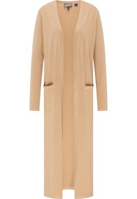 Cardigan long beige en tissu doux avec devant ouvert, manches longues et deux poches avant. Texture lisse et design épuré.