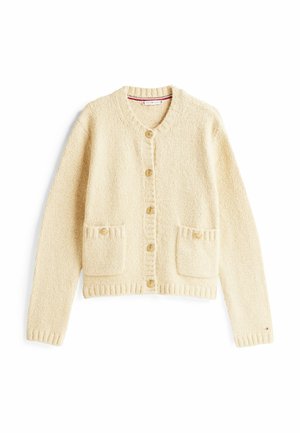 Lyscreme sweater med rund halsudskæring, knaplukning foran og to forlommer. Blød tekstur med ribbet manchetter og kant.