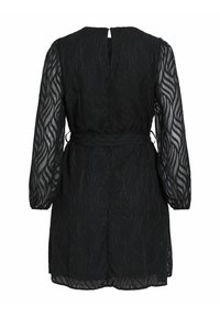 Black dress with long, sheer, puff sleeves, featuring a textured leaf pattern. Includes a belted waist and a keyhole back design.