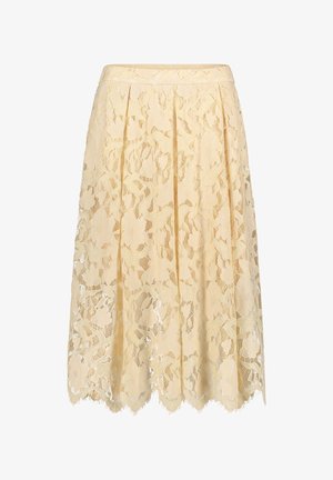 Koronkowa spódnica w jasnosłonecznym żółtym kolorze z kwiatowymi wzorami, plisowanym krojem, falbankowym dołem i przezroczystą fakturą. Miękki materiał z misternymi detalami.