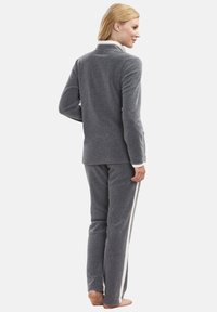 Gray fleece loungewear set featuring a long-sleeve top with a collar and matching pants with a side stripe, designed for comfort.