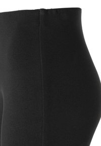 Black leggings made of stretchy fabric, featuring a smooth texture, high waist, and a close-fitting design. No visible patterns or hardware.