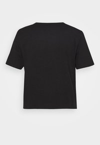 Svart bomulls t-shirt med korta ärmar, rund halsringning och lös passform. Enfärgad utan synliga mönster eller grafik.
