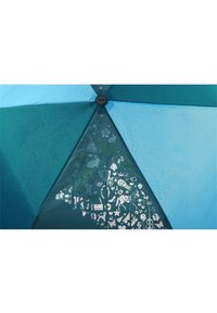 Umbrella featuring a gradient of teal and blue panels, with a waterproof surface. Notable white patterns include various whimsical shapes and animals.