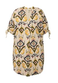 Geprinte tuniek met mouwen tot aan de elleboog. Heeft een beige achtergrond met kleurrijke bloemen- en geometrische patronen. Inclusief een knopenluiting.
