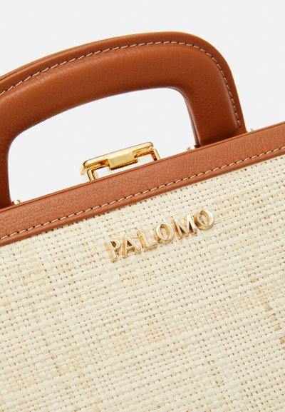 Woven straw handbag with a tan leather handle and gold clasp. Features a gold embossed logo "PALOMO" on the front, with a smooth texture.