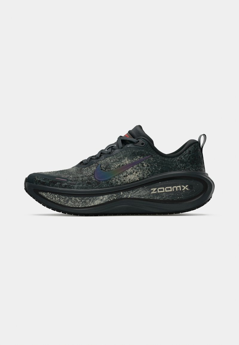 Black and gray Nike ZoomX running shoe with iridescent swoosh logo, thick cushioned sole, laces, and pull tab on plain white background.