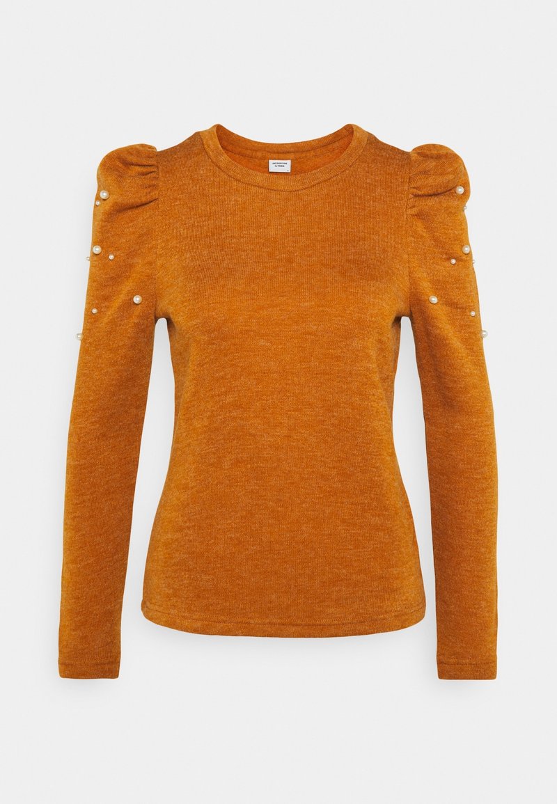 Pull orange brûlé à manches longues avec épaules bouffantes et petites perles blanches dispersées sur le haut des manches.