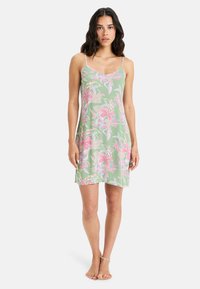 Floral-printed, light green dress with spaghetti straps. Features pink and white floral patterns, soft fabric, knee-length design.