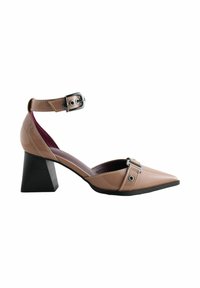 Chaussure à talon haut beige à bout pointu avec finition en cuir verni, bride à la cheville, détails de boucle argentée et talon bloc noir épais.