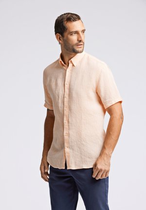 Korte mouw, opknopshirt in licht perziklinnen met een gestructureerde afwerking. Heeft een kraag, een rechte zoom en een comfortabele pasvorm.