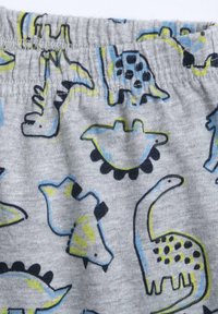 Tissu grise avec un motif de dinosaure en noir, bleu et jaune fluo, présentant diverses formes et contours de dinosaures. Taille élastique.
