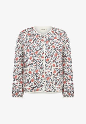 Valge lillelise mustriga kardigan, millel on punased ja sinised lillede motiivid. Kardiganil on ümmargune kaelus, avatud esiosa ja kaks esist taskut, mille servad on kumerad.