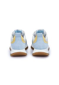 Sneaker bianchi e celesti chiari con una sovrapposizione in suede texturizzato. Presentano un accento giallo, colletto imbottito e suola in gomma marrone.