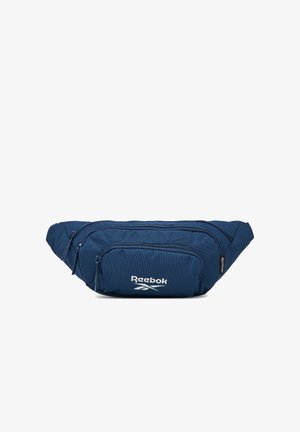 Granatowa saszetka Reebok z trzema zamykanymi na zamek komorami i białym logo na przedniej kieszeni.
