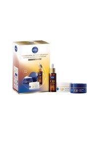 NIVEA Q10 skincare gift set featuring two cream jars (white and blue) and a brown serum bottle, presented in a gold and blue box.