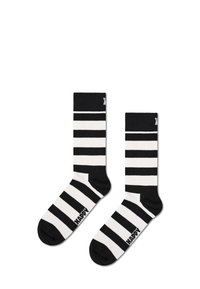 Chaussettes de style crew rayées en noir et blanc, présentant des rayures alternées épaisses et fines, avec un logo sur le bout et en matière tricotée douce.