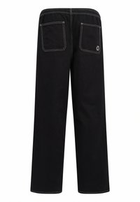 Pantaloni larghi neri con superficie testurizzata, dotati di due tasche posteriori e cuciture bianche a contrasto lungo la cintura e le cuciture.