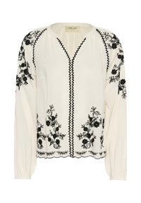 Hvid bluse med sort blomsterbroderi. Har lange ærmer, en V-udskæring og bølget kant. Fremstillet af letvægtsstof.
