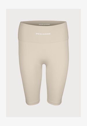 Beige stretch bike shorts with a high waistband, featuring a smooth texture and "PEGADOR" logo in white on the front.