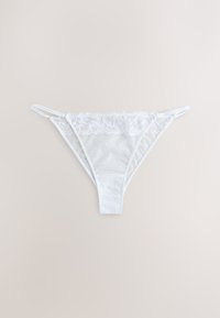 White lace women's bikini-style underwear with floral patterns and thin side straps on a light background.