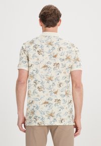 Krátký rukáv košile z krémové bavlny s květinovým vzorem v modrých a hnědých akcentem. Klasický límec a rovný lem.
