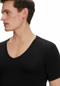 Black short-sleeve V-neck t-shirt made of smooth fabric, featuring a fitted design and seamless shoulder detailing.