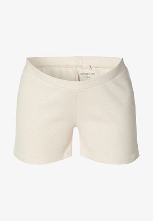 Pantalones cortos de algodón color beige claro con una textura acanalada, que cuentan con una cinturilla ancha y aberturas laterales para facilitar el movimiento. Etiqueta de la marca visible en el interior.