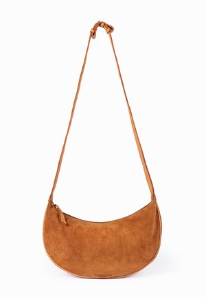 Brown suede crescent-shaped shoulder bag with adjustable strap and zipper closure on a white background.