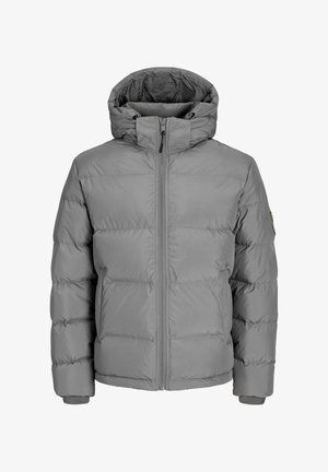 Szürke puffermellény cipzáras fronttal, állítható kapuccsal és bordázott mandzsettákkal. Tűzött kialakítással rendelkezik, sima textúrájú és látható minták nélkül.