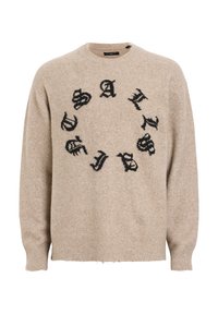 Beige Wollpullover mit rundem Halsausschnitt, ausgestattet mit schwarzem Schriftzug in kreisförmigem Muster. Der Text wirkt abgenutzt, mit gerippten Bündchen und Saum.