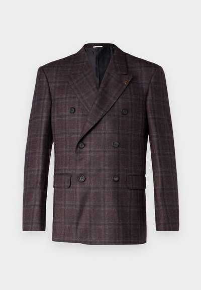 Double-breasted blazer in donkerbruin geruit stof. Heeft twee voorzakken en zwarte knopen. Gevoerde binnenkant met een gekartelde revers.