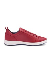 Red leather sneaker with lace-up closure, a rounded toe, and a white midsole. Features a textured finish and a subtle heel tab.