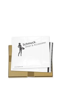 White mailing envelope with a silhouette graphic and "Schmuck, Uhren & Accessoires" printed on it, placed inside a brown cardboard box.