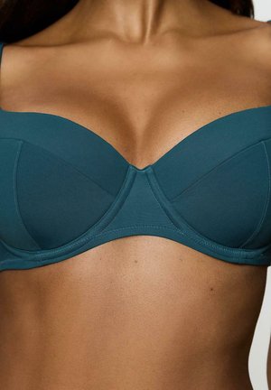 Bikini w kolorze zielononiebieskim, wypełniony miękkim materiałem, z fiszbinami. Posiada głęboki dekolt, pionowe szwy oraz regulowane ramiączka.