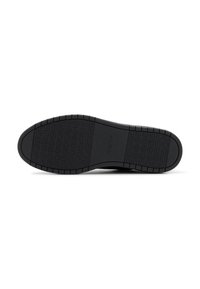 Black rubber shoe sole with textured grip pattern, rounded edges, and raised geometric designs. Durable construction for traction and stability.