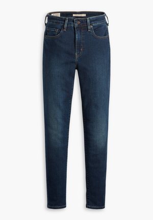 Jeans in denim blu scuro con una vestibilità slim, dotati di cinque tasche, chiusura con bottone standard e leggeri effetti di sfumatura sul davanti.