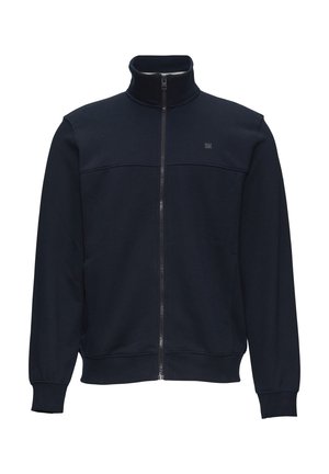 Marineblaue Zip-Jacke aus glattem Baumwoll-Mix. Sie verfügt über einen hohen Kragen, lange Ärmel und ein schlichtes Design mit einem Logo auf der Brust.