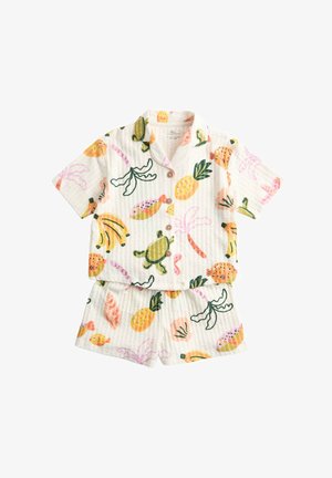 Ensemble chemise à manches courtes boutonnée et short avec motifs colorés de fruits tropicaux, tortues et palmiers sur tissu blanc texturé.