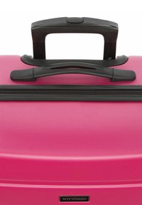 Pink hard-shell suitcase with a textured finish, black zipper, and a telescopic handle. Features a brand logo on a small black accent.